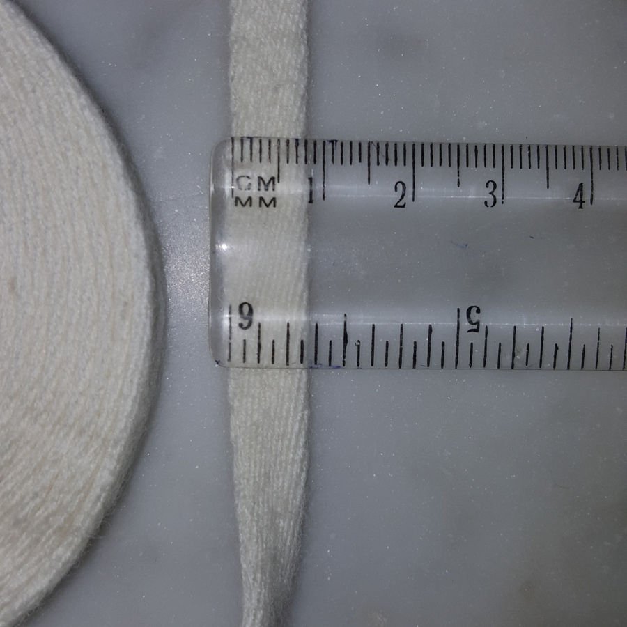 Close-up of a handwoven kasti against a ruler